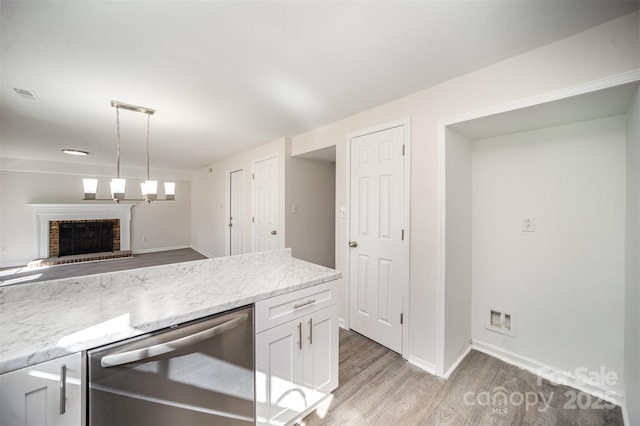 kitchen featuring white cabinetry, light stone countertops, dishwasher, and light hardwood / wood-style floors