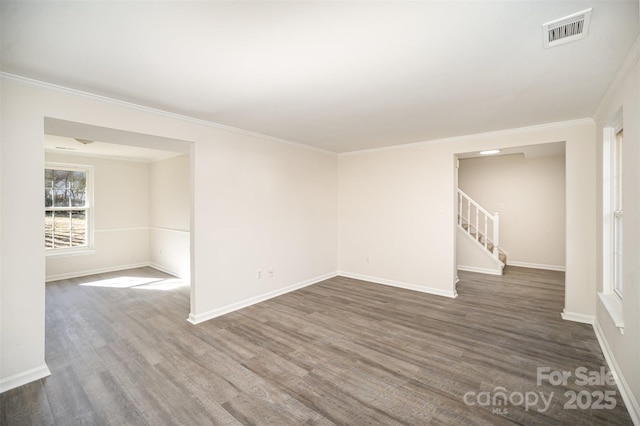 spare room with dark wood-type flooring and crown molding