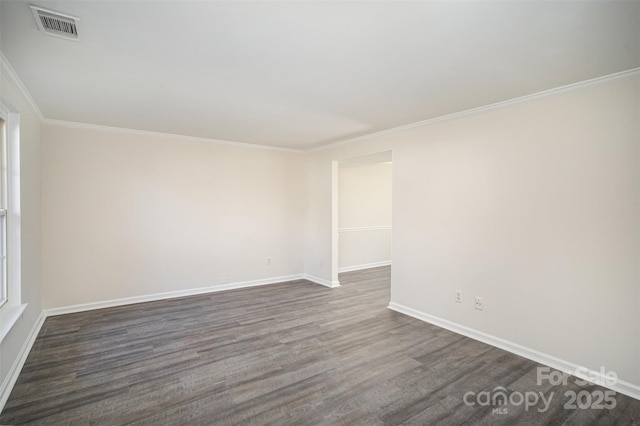 empty room with ornamental molding and dark wood-type flooring