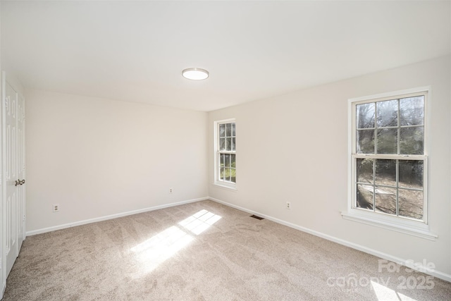 unfurnished room with light carpet