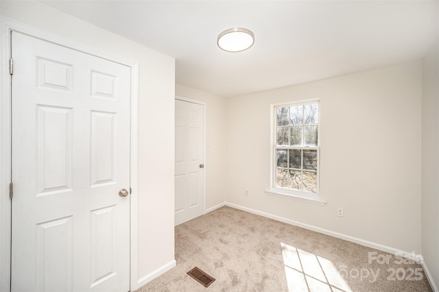 empty room featuring light carpet