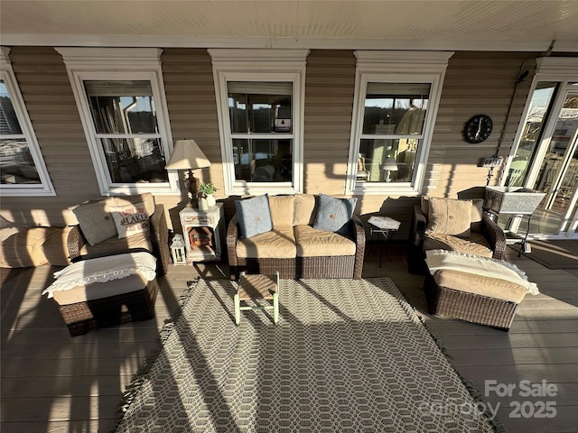 wooden deck with an outdoor living space