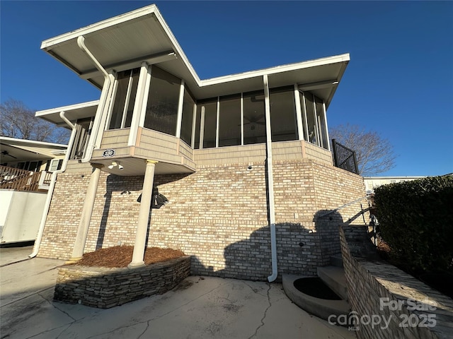 view of property exterior featuring a sunroom