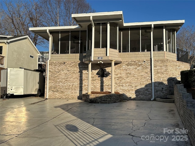 exterior space with a sunroom and a patio