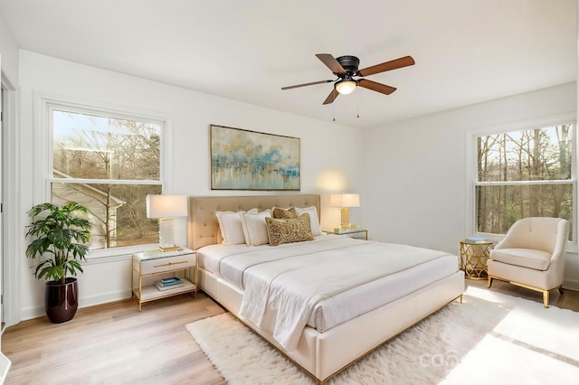 bedroom with ceiling fan and light hardwood / wood-style floors