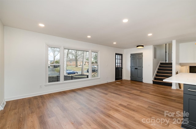 unfurnished living room with light hardwood / wood-style floors