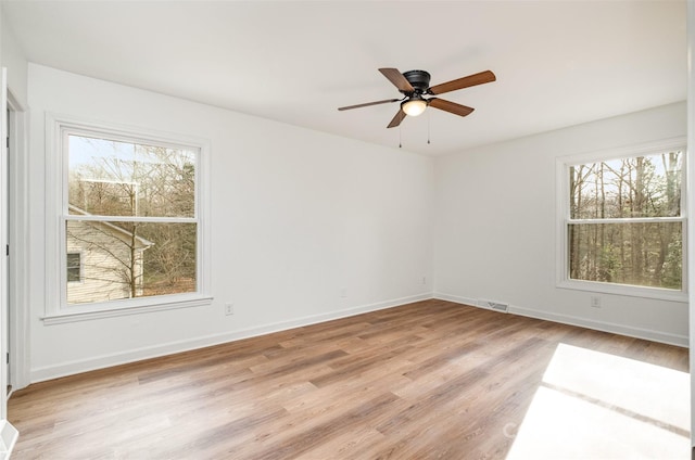 empty room with light hardwood / wood-style flooring and ceiling fan