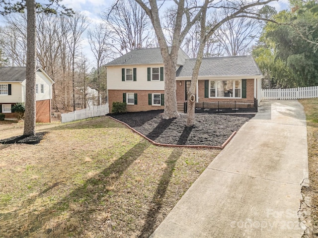 tri-level home with a front yard