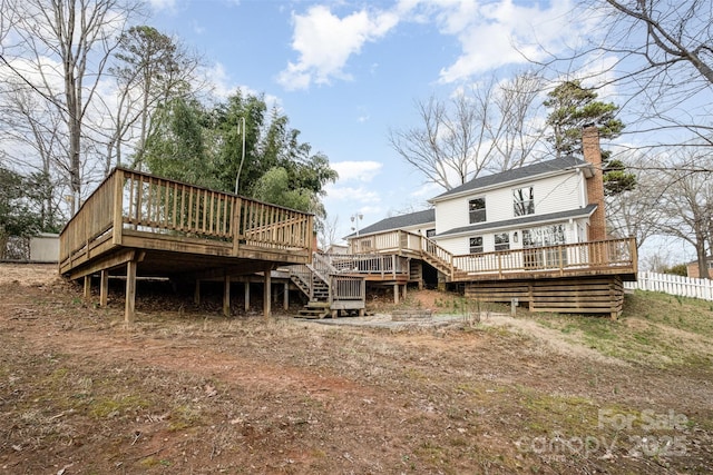 rear view of property featuring a wooden deck