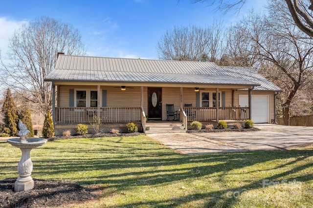 view of front of home featuring a garage, driveway, metal roof, a porch, and a front yard