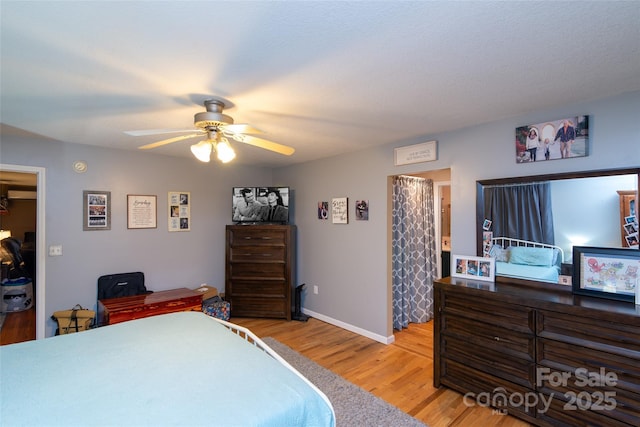 bedroom with light hardwood / wood-style floors and ceiling fan