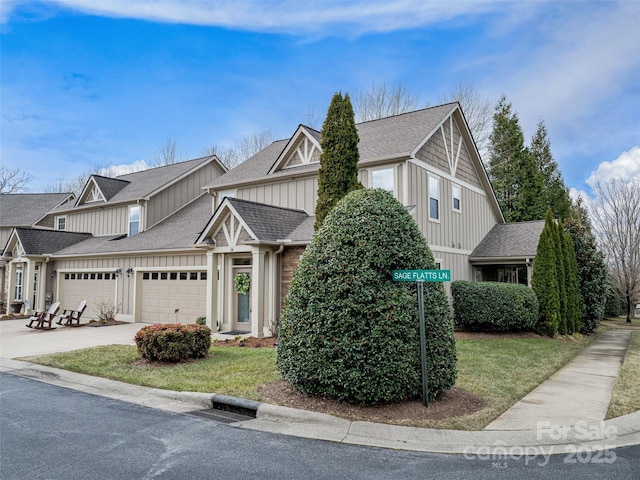 view of front of house featuring a garage and a front lawn