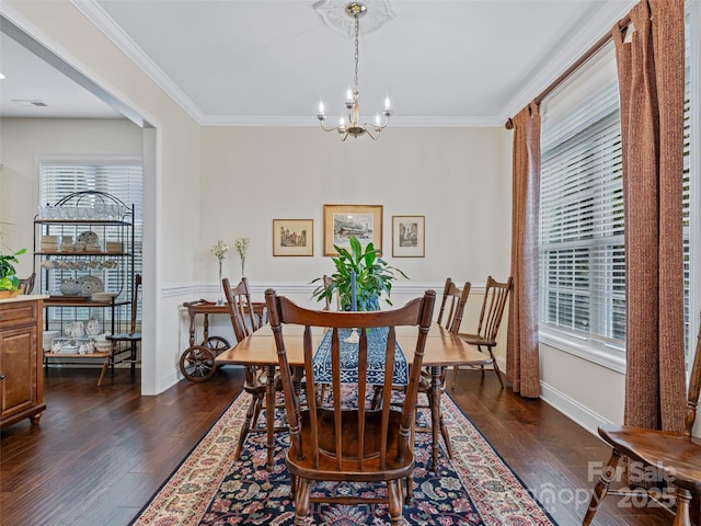 dining space with ornamental molding, dark hardwood / wood-style floors, and a notable chandelier