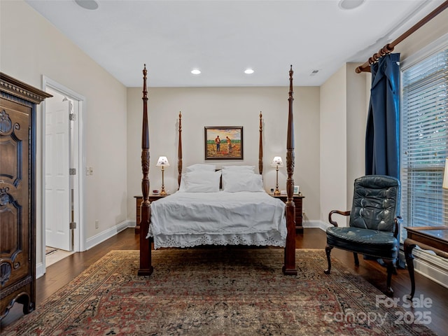 bedroom with dark hardwood / wood-style flooring