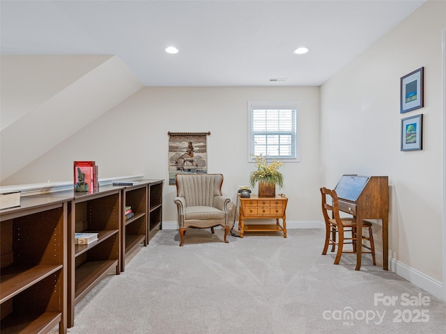 living area featuring light carpet