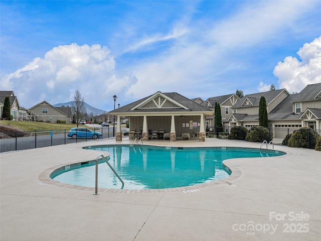 view of pool with a mountain view and a patio