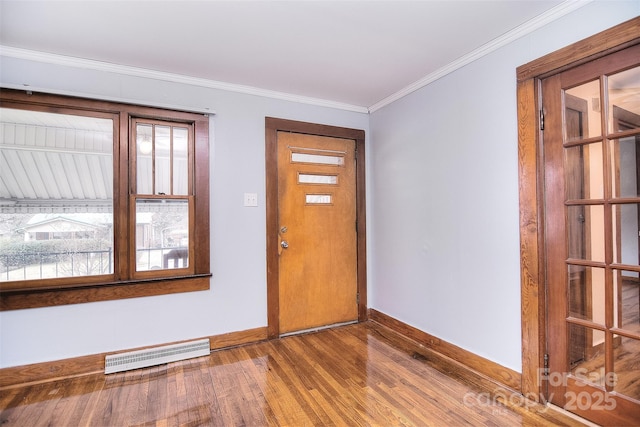 foyer entrance with crown molding and wood-type flooring