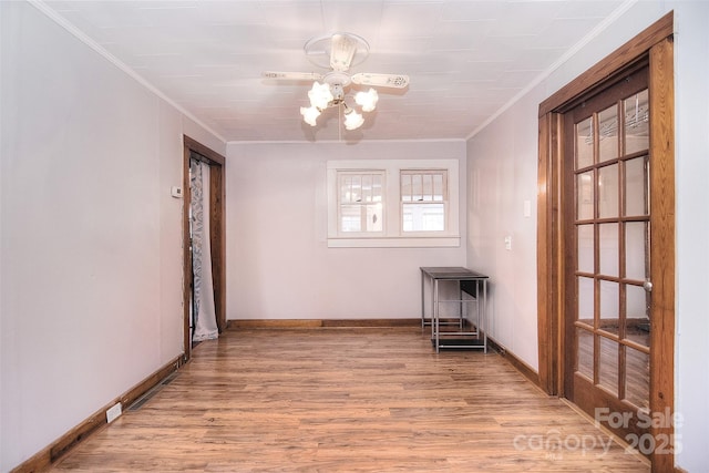 unfurnished room with crown molding and light hardwood / wood-style flooring