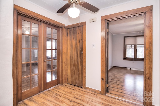 interior space with light hardwood / wood-style flooring, ornamental molding, and ceiling fan