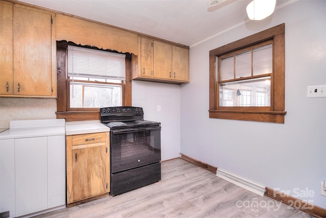 kitchen with electric range, ornamental molding, and light wood-type flooring