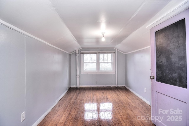 additional living space with lofted ceiling and hardwood / wood-style floors