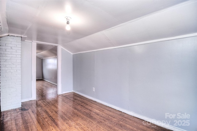 additional living space featuring hardwood / wood-style flooring and lofted ceiling