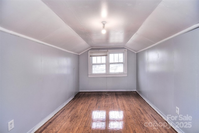 bonus room featuring dark wood-type flooring and vaulted ceiling