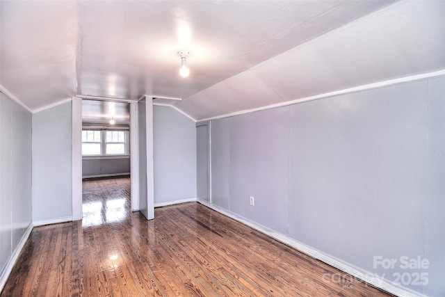 bonus room with wood-type flooring and lofted ceiling