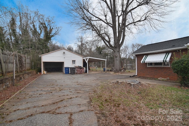 view of home's exterior with a garage, an outdoor structure, and a carport