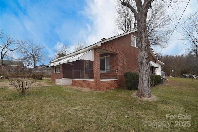 view of home's exterior with a lawn and covered porch