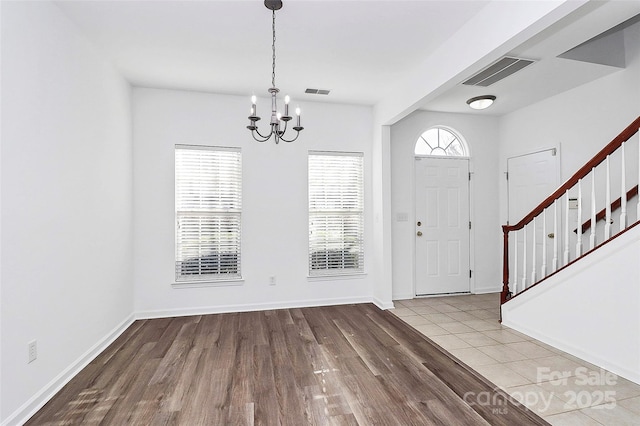 entrance foyer with a notable chandelier and light hardwood / wood-style flooring