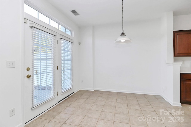 unfurnished dining area with light tile patterned flooring