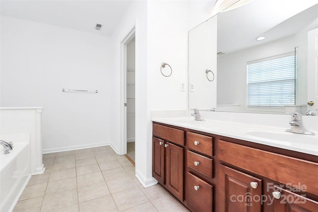 bathroom featuring a tub to relax in, tile patterned floors, and vanity