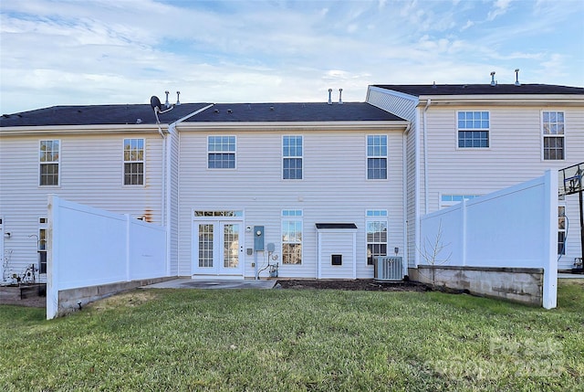 rear view of property featuring a patio, a yard, and cooling unit