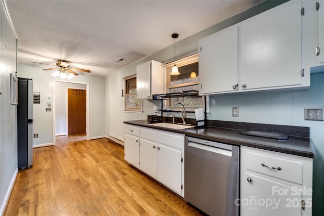 kitchen featuring sink, baseboard heating, appliances with stainless steel finishes, light hardwood / wood-style floors, and white cabinets