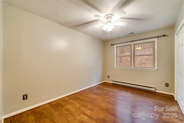 unfurnished room featuring wood-type flooring, ceiling fan, a textured ceiling, and baseboard heating