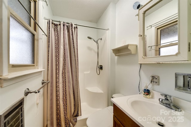 bathroom with vanity, toilet, a textured ceiling, and a shower with shower curtain