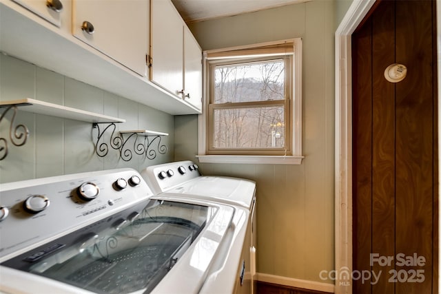 laundry area with cabinets and washing machine and dryer