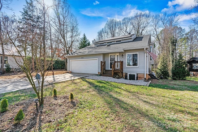 view of front of house with a garage, cooling unit, and a front lawn