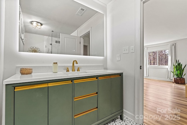 bathroom with ornamental molding and vanity