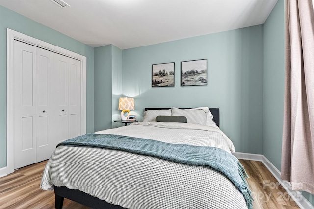 bedroom featuring hardwood / wood-style floors and a closet