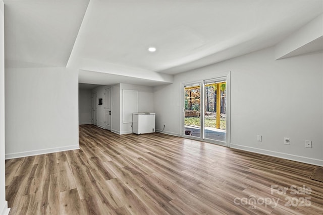 unfurnished living room with light hardwood / wood-style floors