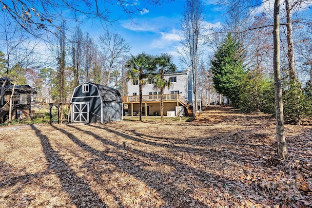 back of property with a shed and a deck