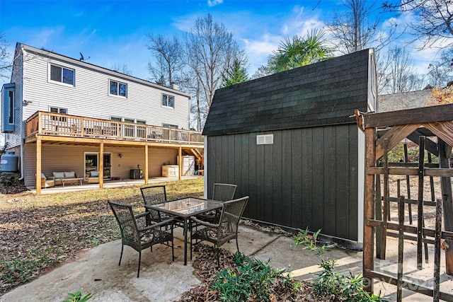 view of patio / terrace featuring an outbuilding and a wooden deck