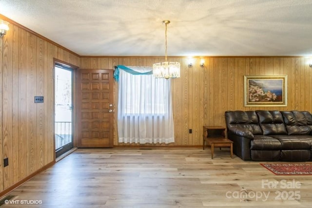 living room with ornamental molding, wood-type flooring, and a wealth of natural light