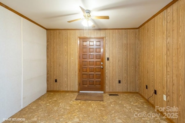 foyer with ornamental molding and ceiling fan