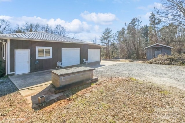 exterior space featuring a storage shed and a garage