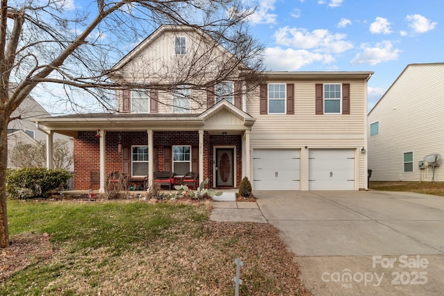 view of front property featuring a garage, a front lawn, and covered porch