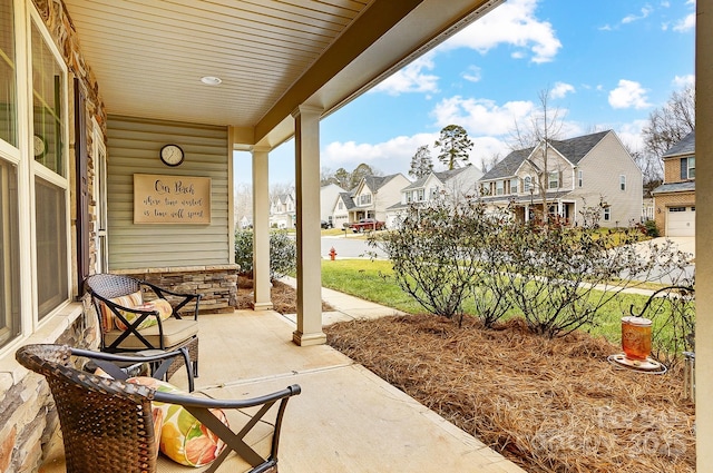 view of patio / terrace featuring a porch and a residential view