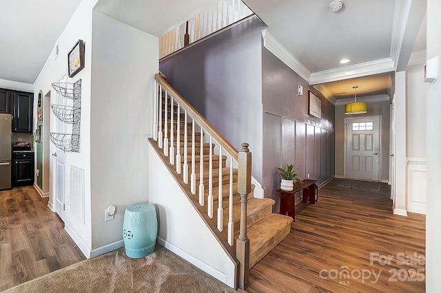 entryway with recessed lighting, dark wood-style flooring, baseboards, ornamental molding, and stairway